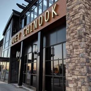 Joey Chinook restaurant exterior with a stone and glass facade and lit signage